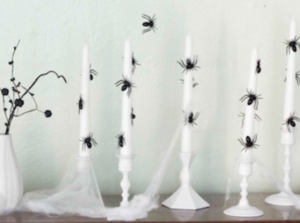 Ghostly Spider Mantel with white candles and spider webs with spiders