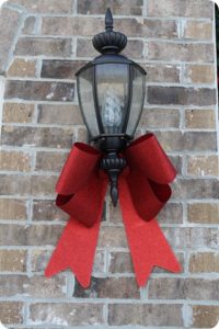 Festive Christmas Porch Light decorated with a bow