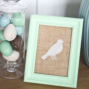 painted bird on burlap in picture frame