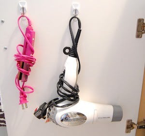 behind the cabinet door hair appliance storage using command hooks