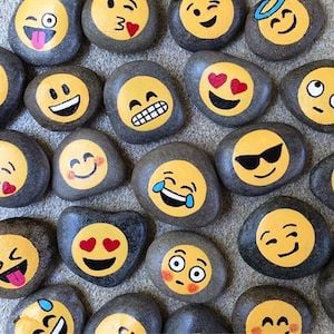 rocks painted with emojis