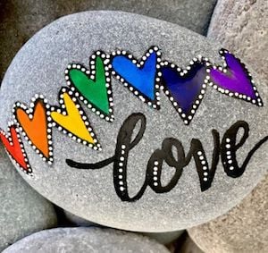 love word stone with rainbow hearts