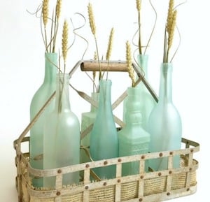 Sea Glass Bottles centerpiece in a metal basket