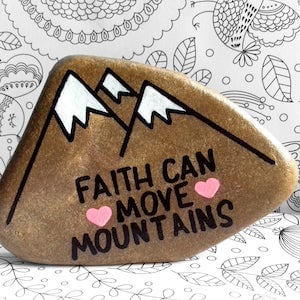 Faith Can Move Mountains word rock with mountains in the background