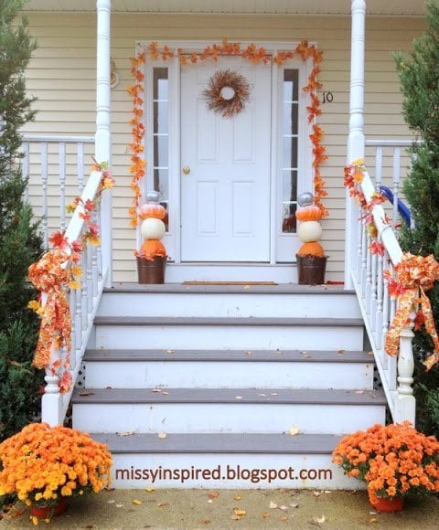 simple fall garland porch with mums and a pumpkin topiary 