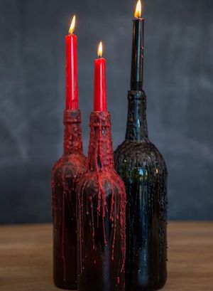 red Dripping Candles in black wine bottles halloween party centerpiece 