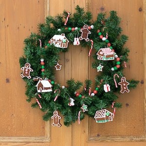 traditional greenery christmas wreath with candy cane and gingerbread ornaments