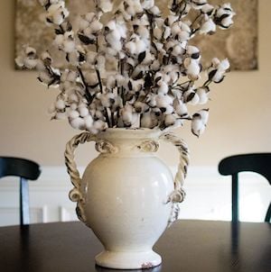 cotton stems in a vase on farmhouse kitchen table