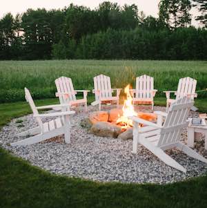 large Rock Fire Pit with Chairs and Gravel