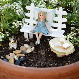 Fairy Sitting on a Bench in a terra cotta pot