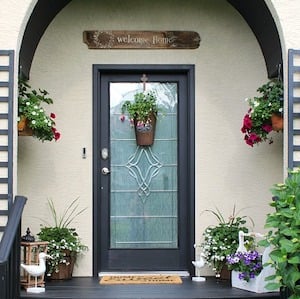 potted plants on the front porch next to the door