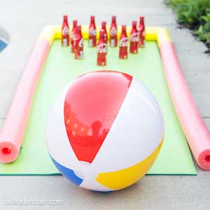 Outdoor Bowling Game with beach ball and soda bottles