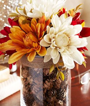 mini pinecones in a twine wrapped vase with mums