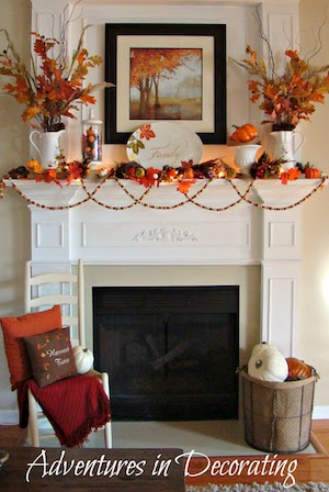 Traditional Fall Mantel with fall leaves in a vase and fall leaf garland 