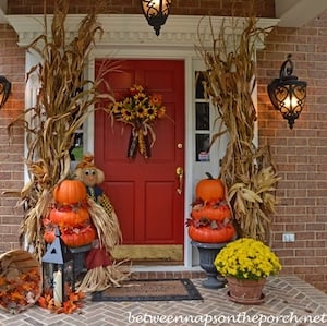 DIY Pumpkin Topiaries with dried cornstalks in the entryway 