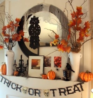 DIY Halloween Mantel Decorations with trick or treat garland and fall branches in vases