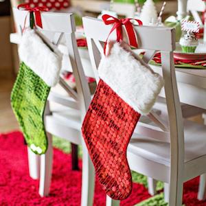 apartment Christmas Stockings tied to Dining Room Chairs