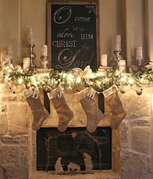 rustic lit up christmas Mantel with burlap stockings