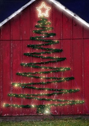 large faux Christmas Tree on barn