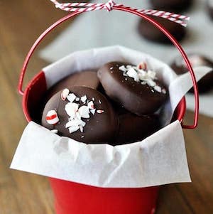 homemade peppermint patties in a christmas tin gift