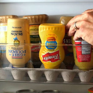 DIY Condiment Bottle Organization with upside down condiment bottles in egg cartons