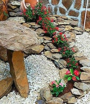  Spilling Flower Pot with flowers and rocks