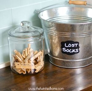 laundry room organization for the counter top with jar and bucket