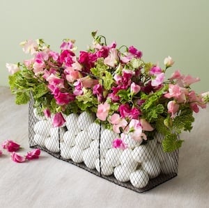 DIY Easter Basket Centerpiece filled with eggs and spring flowers