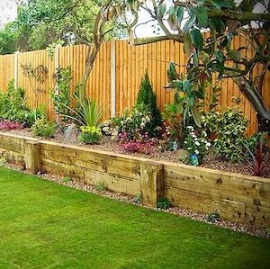 backyard raised planter along fence landscaping idea