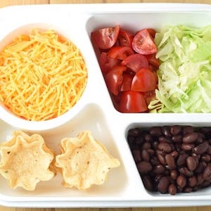 Mini Tacos with Tortilla Chips, Black Beans, Cheese, Lettuce, and Tomatoes