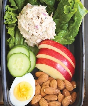 Tuna Salad on lettuce with apples, nuts Kids lunch box 