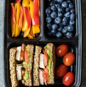 chicken sandwich with tomatoes and blueberries lunch box