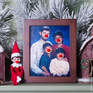 Elf putting clown noses on pictures