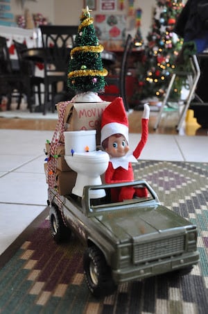 Elf Packed Up and driving away in toy car
