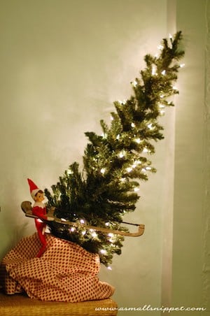 Elf on shelf Cutting Down Christmas Tree 
