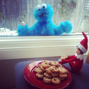 elf eating cookies while Cookie Monster Locked Outside