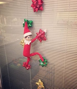 Climbing the Window with mini gift bows Elf on the Shelf Ideas