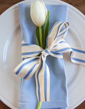 blue napkin with blue stripped bow and tulip