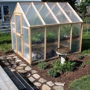 simple everyday greenhouse made from wood and plastic sheeting