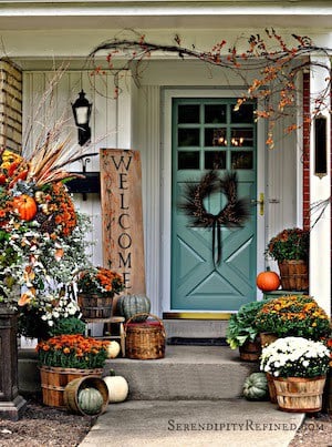 fall porch decor with orange turquoise and white mums, pumpkins