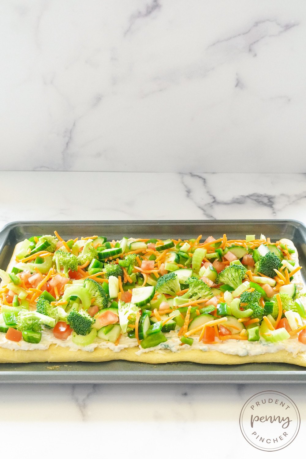 close up of crescent roll veggie pizza appetizer on sheet pan