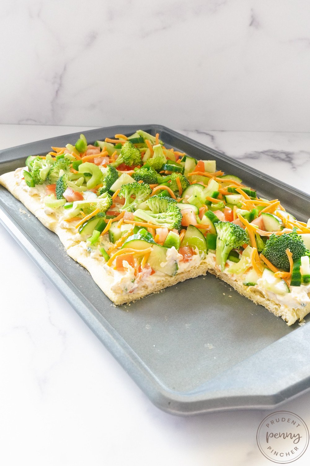 picture of crescent roll veggie pizza appetizer on sheet pan