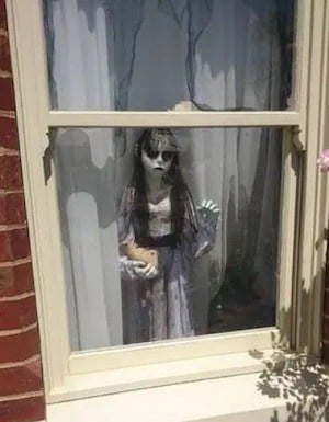 scary ghost standing by the window