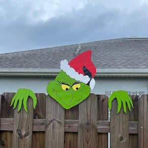 grinch peaking over fence christmas decoration for outside