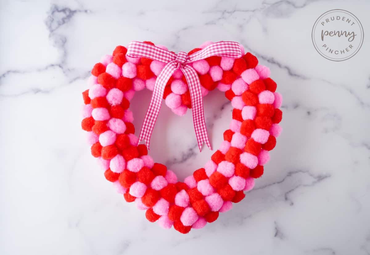 red and pink pom pom heart wreath