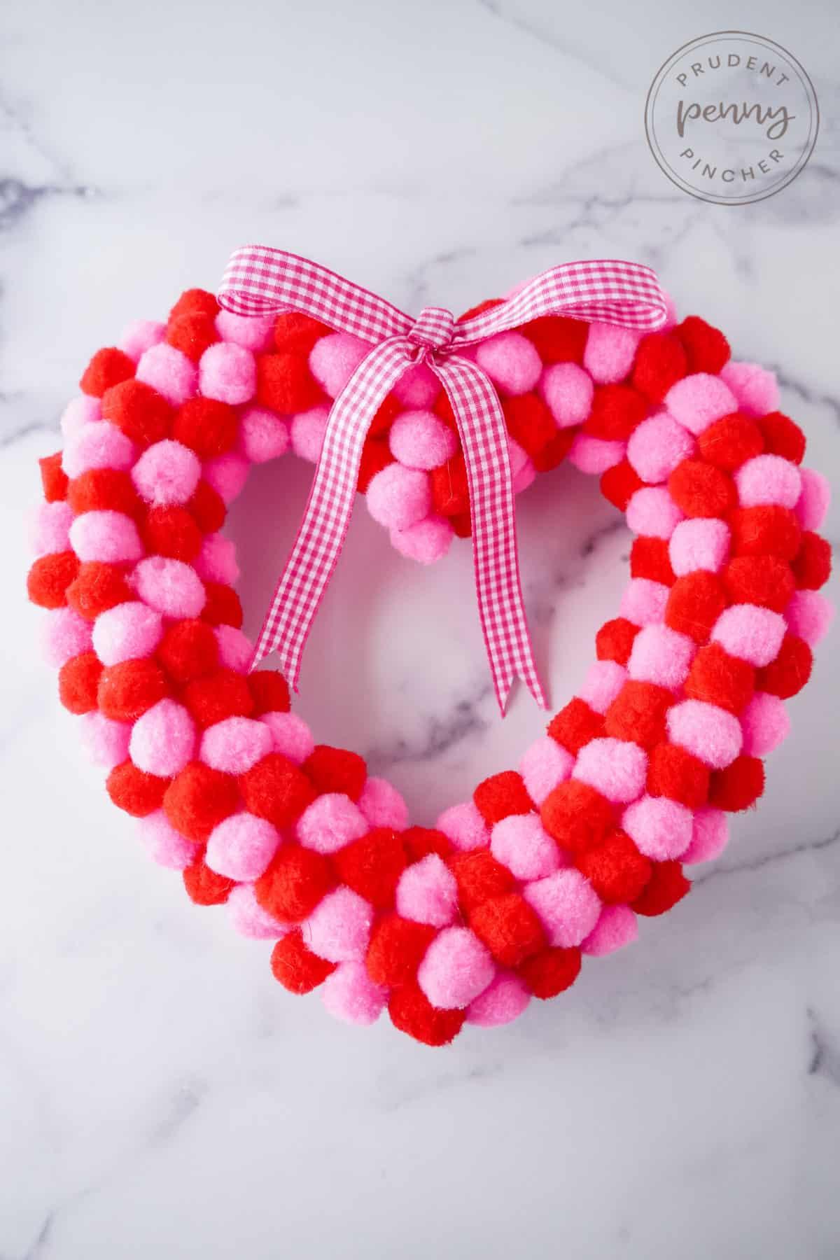 red and pink heart wreath with a pink ribbon 