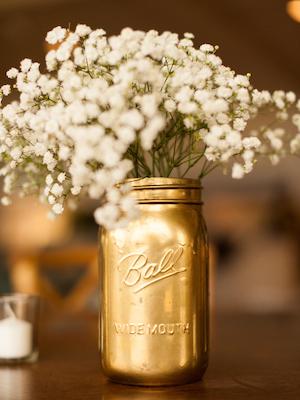 gold mason jar wedding centerpiece with baby's breath
