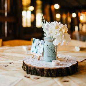 mason jar wedding centerpiece on wood slice