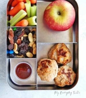 meatball lunch box with an apple