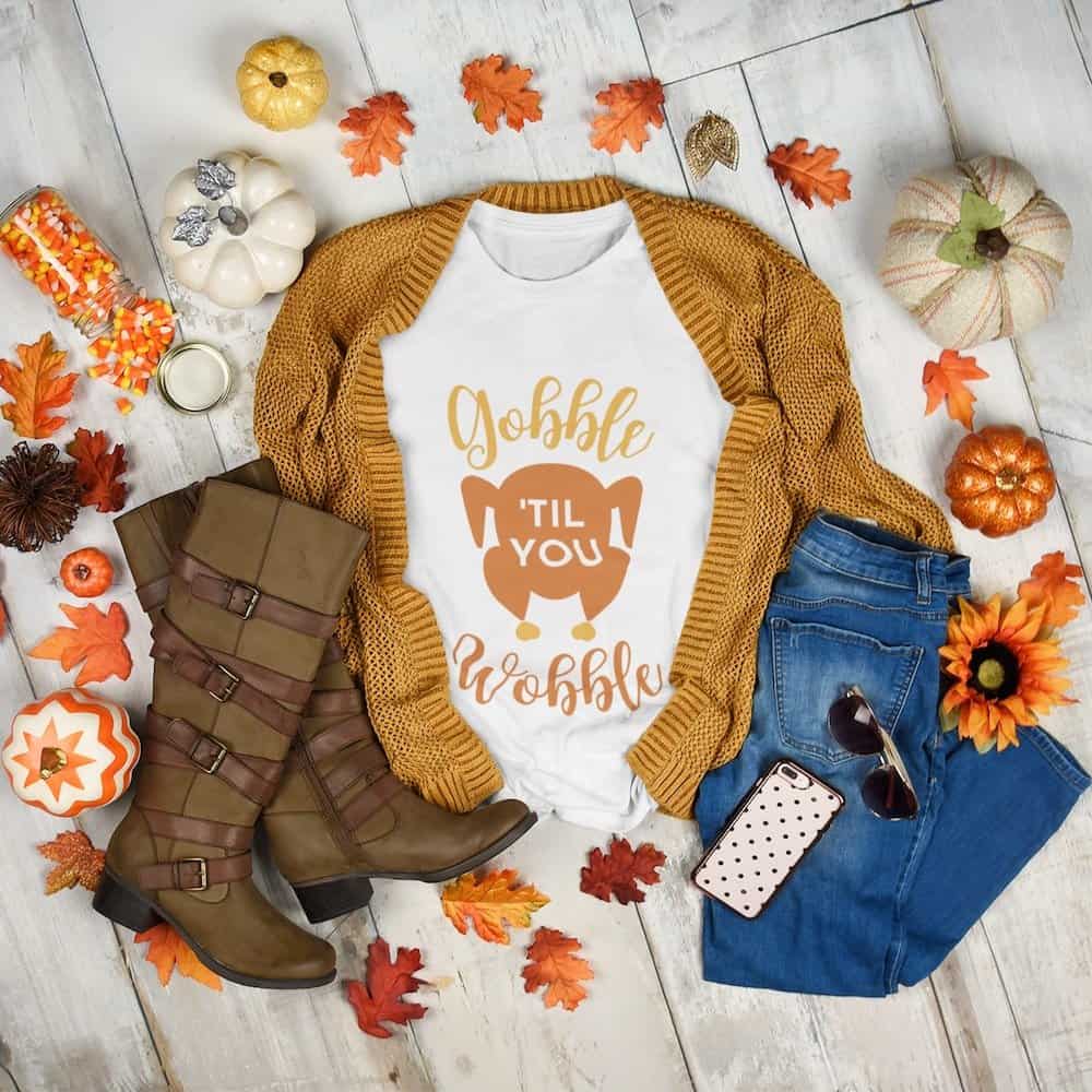gobble til you wobble thanksgiving svg file on a t-shirt with a fall background